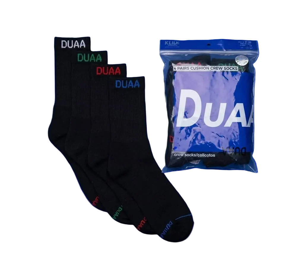 Four pairs of black crew socks with colorful DUAA branding in white, green, red, and blue, shown next to their blue packaging bag on a white background.