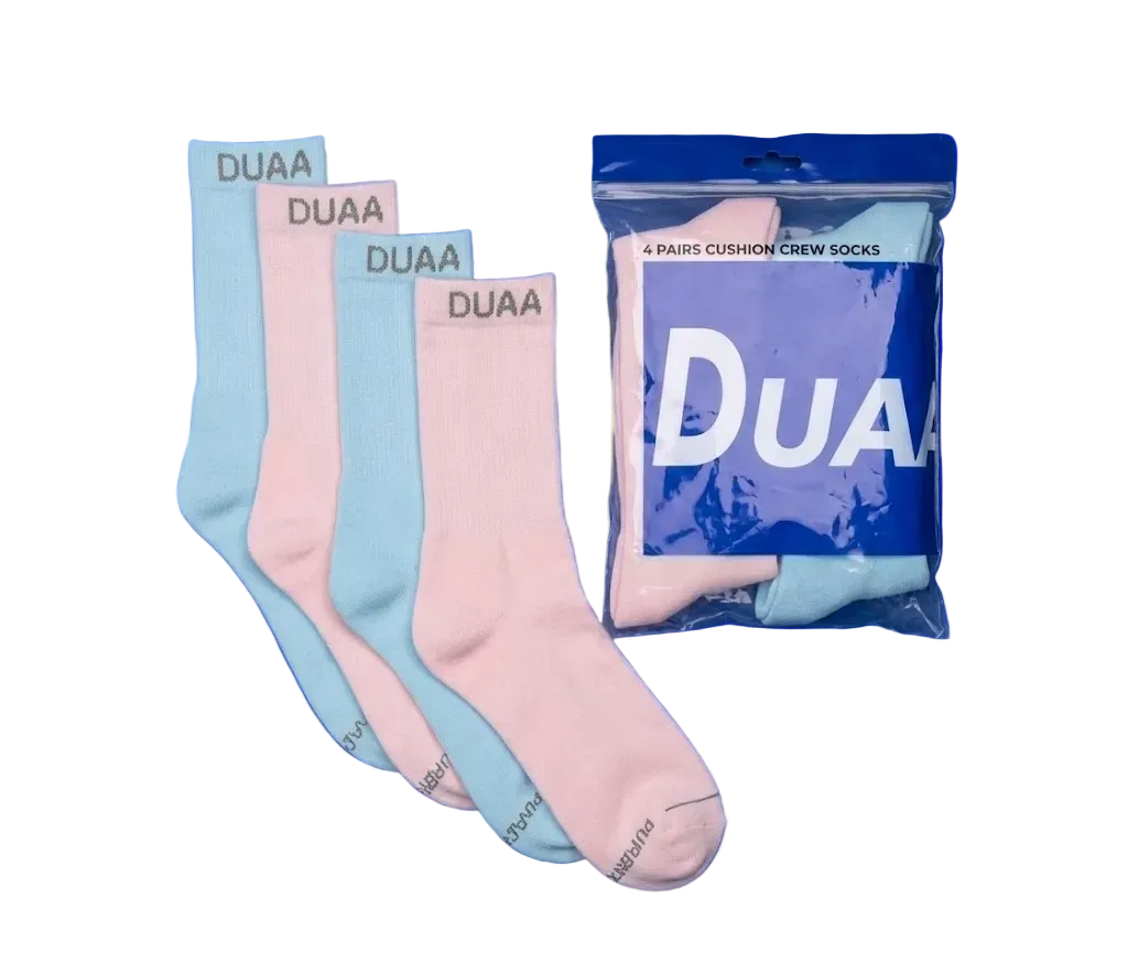 Four pairs of DUAA cushion crew socks in pastel blue and pink, shown with one sock unfolded and three folded pairs fanned out next to their blue branded packaging bag. The brand name 'DUAA' is visible on the socks and packaging.
